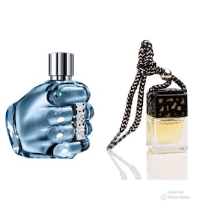 May include: A blue glass bottle of cologne shaped like a fist with a silver cap. A small black and silver bottle of cologne with a black cord hanging from it.