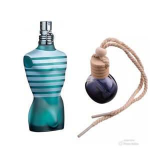 May include: A blue glass bottle with a striped design and a silver spray nozzle. A smaller blue glass bottle with a wooden cap and a brown rope is hanging from the top.