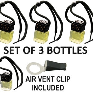 May include: Set of three black and gold car air fresheners with a string for hanging. Each bottle is filled with a clear liquid. The set includes an air vent clip.