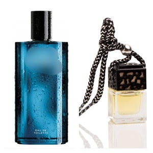 May include: A blue glass bottle of eau de toilette with a black cap and a black and white string hanging from a small clear glass bottle with a black cap and a black and white string.
