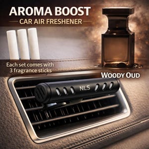 May include: A black car air freshener with the text "NLS" and a "Woody Oud" scent. The image also shows three white fragrance sticks and a brown bottle. The text "AROMA BOOST CAR AIR FRESHENER" is at the top.