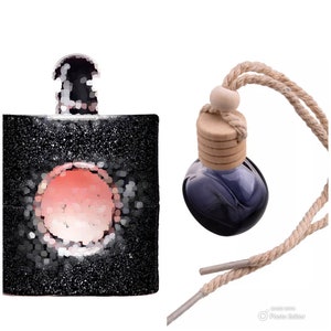 May include: A black and silver perfume bottle with a pink circle in the centre. A blue glass bottle with a wooden lid and a brown rope is hanging from the top.