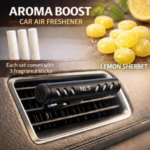 May include: Black car air freshener with the text "AROMA BOOST" and "CAR AIR FRESHENER". The image shows a car vent with a black air freshener and three white fragrance sticks. The text "LEMON SHERBET" is also visible.
