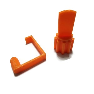 May include: Two orange plastic pieces, one is a small gear with a flat top and the other is a curved piece shaped like a bracket.
