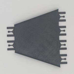 May include: A black plastic corner tile trim piece with a triangular shape and a series of small teeth along the edges.