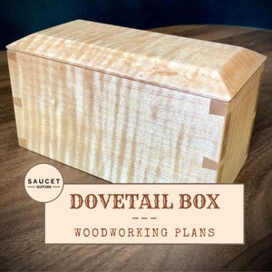 May include: A wooden dovetail box with a light wood finish. The box is closed and has a simple design. The text "Dovetail Box" and "Woodworking Plans" is printed on a beige background below the box.