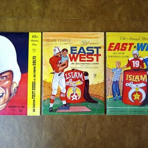 May include: Three vintage program covers for East-West All-Star Football Games. The covers feature a red, white, and blue color scheme with the words "East-West" and "Islam Temple" in bold lettering. The programs are from 1960 and 1961.