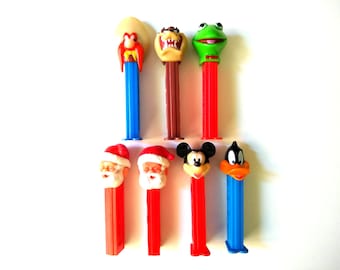 Lot of 7 Vintage Pez Dispensers, Yosemite Sam Made Slovenia, Tasmanian Devil (Hungary), Kermit the Frog (Hungary), Santas (Yugoslavia), More