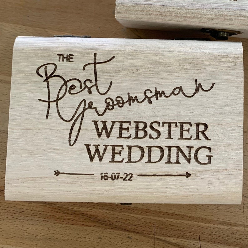 May include: A wooden box with the text "The Best Groomsman Webster Wedding 16-07-22" engraved on the top.