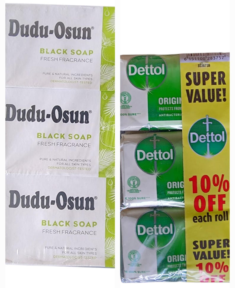 Puede incluir: La imagen muestra tres barras de jab&oacute;n negro Dudu-Osun y tres barras de jab&oacute;n antibacteriano Dettol. El jab&oacute;n Dudu-Osun tiene un embalaje blanco con detalles verdes. El jab&oacute;n Dettol est&aacute; en un embalaje verde y blanco con una pancarta promocional amarilla.