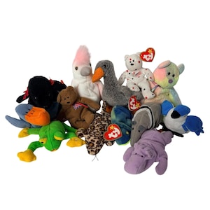 May include: A collection of colorful plush toys, including a brown bear with a Union Jack, a white bear with star patterns, a gray goose, a pink and white bird, and a green frog. Various other animal plushies are also present.