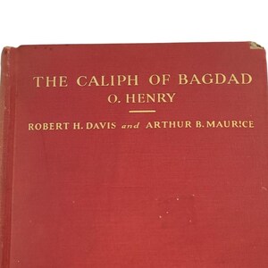 May include: The Caliph of Bagdad by O. Henry, a book with a red cover and gold lettering.