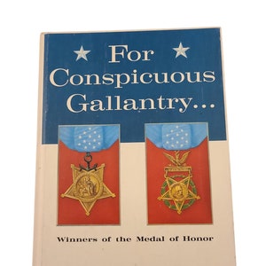 May include: A book titled "For Conspicuous Gallantry... Winners of the Medal of Honor" by Donald E. Cooke. The cover features two images of the Medal of Honor.