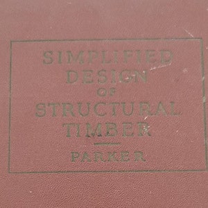 May include: A brown book with the title "Simplified Design of Structural Timber" by Parker.