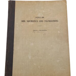 May include: An aged book titled "Notes on Soil Mechanics and Foundations" by Fred L. Plummer. The cover is a faded beige with a dark brown spine. The text is in black, with some discoloration and wear visible on the cover.