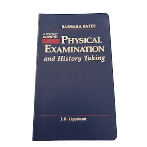 May include: A navy blue book titled "A Pocket Guide to Physical Examination and History Taking" by Barbara Bates. The book's cover features white text and the publisher's name, J. B. Lippincott.