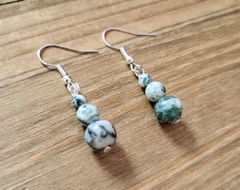 May include: A pair of silver dangle earrings with three green and white agate beads on each earring.