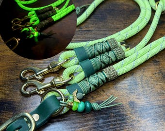 May include: Neon green dog leash with gold-colored hardware and decorative green and brown accents. The leash features a braided design and a leather handle with a gold-colored buckle. A smaller inset image shows the leash glowing.