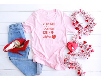 Könnte beinhalten: Pinkes T-Shirt mit dem Text "My Favorite Valentine Calls Me Maria" in Rot mit einem roten Herzen.