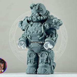 May include: A gray 3D printed figurine of a robot wearing a detailed power armor suit. The robot has a helmet with a visor and a large, round chest piece. The figurine is standing on a white surface.