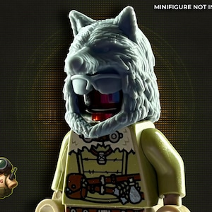 May include: A light grey wolf head mask on a Lego figure. The figure wears a tan shirt with a brown satchel and a weapon. The text "MINIFIGURE NOT INCLUDED" is at the top.