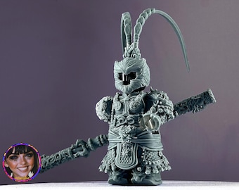 May include: A gray 3D printed figurine of a monkey warrior wearing a detailed helmet and armor. The figurine is holding a staff with a decorative end.