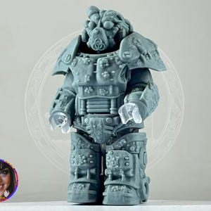 May include: A gray 3D printed action figure of a robot wearing a detailed power armor suit. The robot has a helmet with a visor and a detailed face.