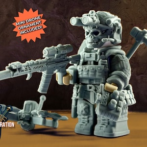 May include: A gray toy figurine of a soldier with a skull-shaped helmet, holding a rifle and a pickaxe. A mini drone ornament is included. The word "COLLABORATION" is also visible.