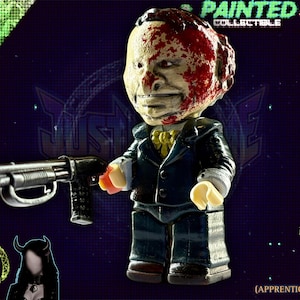 May include: A painted collectible figure of a man in a suit, holding a shotgun. The figure has a blood-splattered head and is labelled "Painted Collectible" and "JustMyGome". The text "Modelled in 3D without the use of A.I. (Apprentice Grade)" is also visible.