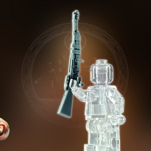 May include: A transparent Lego minifigure holding a gray plastic rifle. The minifigure is standing on a brown background with a circular design.