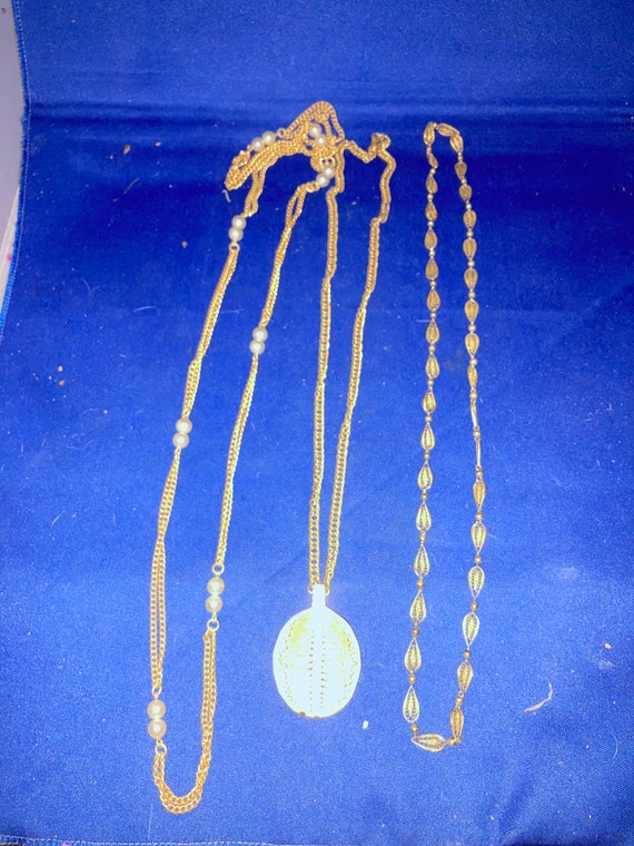 3 gold colored metal necklaces.