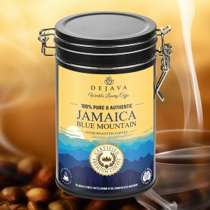 Könnte beinhalten: Eine schwarze und gelbe Kaffeedose mit Klappdeckel. Auf dem Etikett steht "DEJAVA Jamaica Blue Mountain Hand Roasted Coffee". Das Design zeigt eine Berglandschaft und den Text "100% Pure & Authentic". Die Dose ist mit "Certified Premium Coffee" gekennzeichnet.