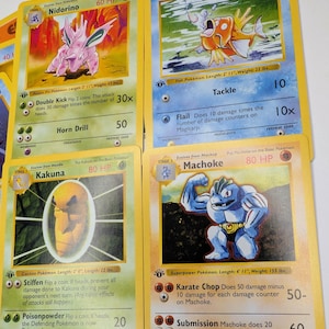 May include: Assortment of vintage Pok&eacute;mon trading cards featuring characters like Nidorino, Magikarp, Kakuna, and Machoke. Each card displays character art, HP, attacks, and game text. The cards have yellow borders and are in various conditions.