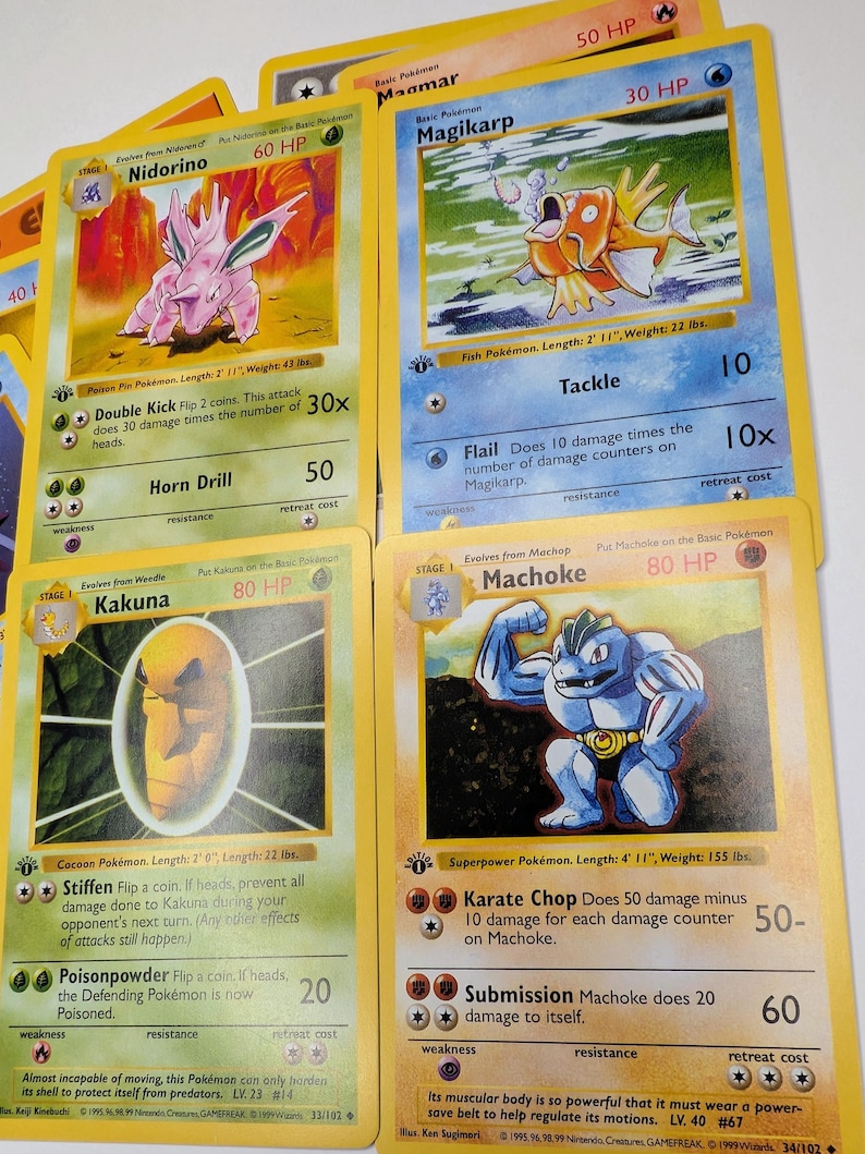 May include: Assortment of vintage Pok&eacute;mon trading cards featuring characters like Nidorino, Magikarp, Kakuna, and Machoke. Each card displays character art, HP, attacks, and game text. The cards have yellow borders and are in various conditions.