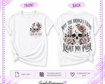 May include: A white t-shirt shown from the front and back. The front features a small graphic of a skull with flowers and the text "LIGHT MY PATH". The back displays a larger version of the same skull and floral design with "MAY THE BRIDGES I BURN LIGHT MY PATH" printed in black.