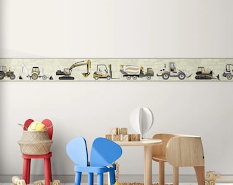 May include: A white wall with a border of construction vehicles in yellow, black, and gray. The vehicles include a bulldozer, excavator, forklift, cement mixer, and a dump truck. The border is above a playroom with a blue chair, a wooden table, and a woven rug.