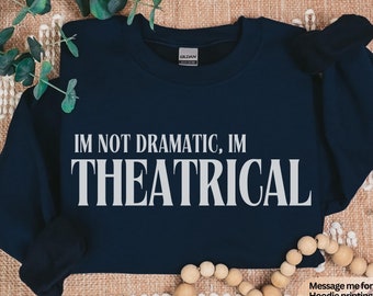 May include: Navy blue sweatshirt with the text "IM NOT DRAMATIC, IM THEATRICAL" in white lettering.