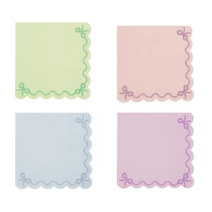 May include: Four pastel-colored square notepads. Each notepad has a scalloped edge and bow accents in the corners. The colors are light green, pink, blue, and purple. The notepads are on a white background.