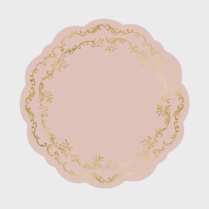 May include: A circular scalloped paper plate in a soft dusty pink color featuring a metallic gold foil filigree border pattern. The intricate gold design follows the rounded edge of the plate, creating a decorative frame around the solid pink center.