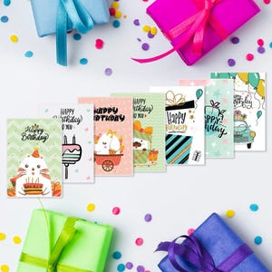 May include: A set of eight colorful birthday cards with different designs. The cards feature cute illustrations of animals, gifts, and balloons. The text on the cards says "Happy Birthday".