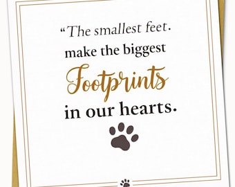 May include: A white greeting card with a gold border and a gold envelope. The card features the text "The smallest feet. make the biggest Footprints in our hearts." in black and gold script, with a paw print graphic.