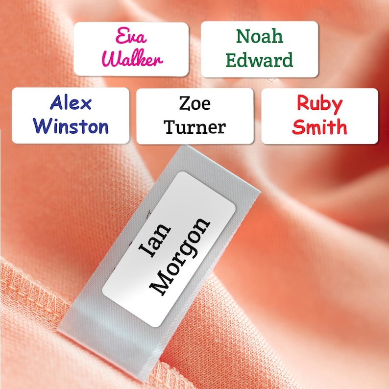 May include: A collection of rectangular white clothing labels featuring various names printed in different colors and fonts, including Eva Walker, Noah Edward, Alex Winston, Zoe Turner, Ruby Smith, and Ian Morgon, displayed on a peach fabric.