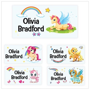 May include: Six different designs of personalised name labels featuring a unicorn with a rainbow and clouds. The name "Olivia Bradford" is printed on each label.