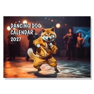 May include: A calendar titled DANCING DOG CALENDAR 2027 featuring a Shiba Inu dog wearing a bright yellow tracksuit and performing a dance move on a stage with warm orange lighting and blurred figures in the background.