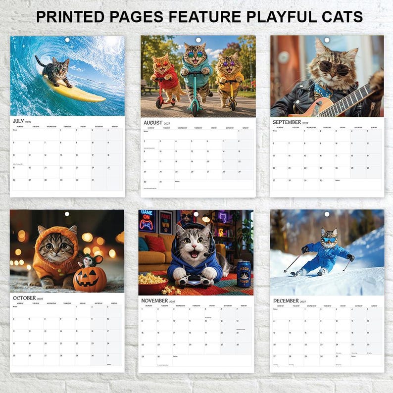 May include: A wall calendar featuring six pages with the text PRINTED PAGES FEATURE PLAYFUL CATS. Each page displays a monthly grid for 2027 and a photograph of cats in various activities, including surfing, riding scooters, playing guitar, and skiing.