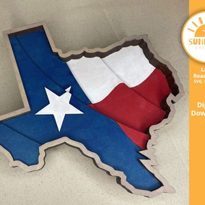 May include: A wooden cutout of the state of Texas with the Texas flag design. The flag is blue, white, and red. The cutout is ready to be used for laser cutting projects.