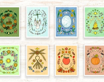 May include: Eight illustrated cards depicting the eight sabbats of the Wheel of the Year. Each card features a different color background and a circular design with symbols and imagery representing each sabbat. The sabbats are Yule, Imbolc, Ostara, Beltane, Litha, Lammas, Mabon, and Samhain.