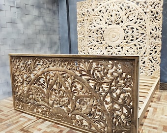 May include: A wooden headboard with intricate carved floral designs. The headboard is made of light wood and has a natural finish. The headboard is a beautiful and unique piece of furniture that would add a touch of elegance to any bedroom.