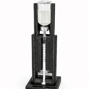 Könnte beinhalten: Schwarze Injektionshalterung mit einer transparenten Ampulle und einer Spritze. Die Halterung ist so konzipiert, dass sie die Ampulle und die Spritze sicher hält. Der Text auf dem Bild lautet "Injection Support Fixture".