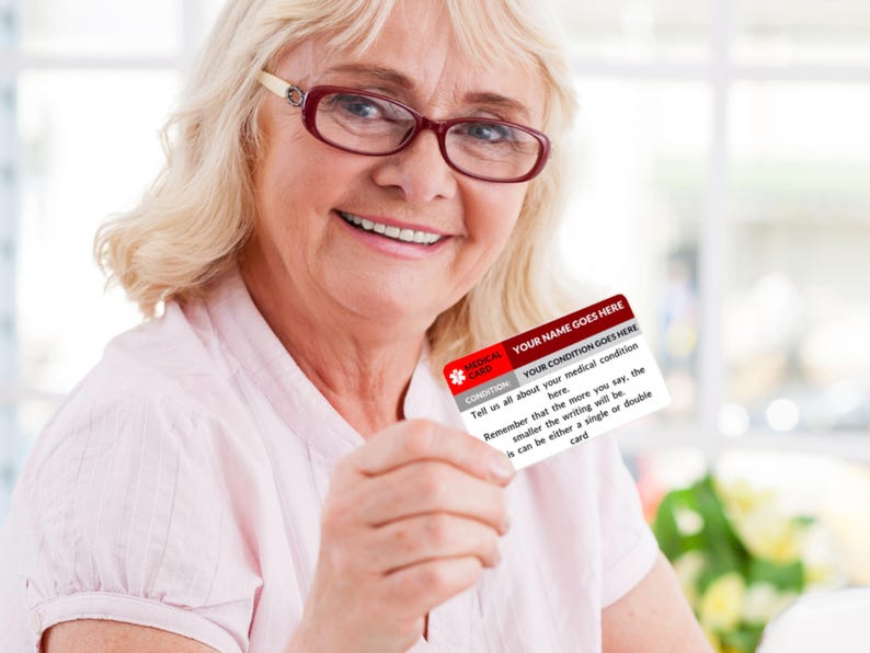 May include: A white medical alert card with red accents. The card has the text "YOUR NAME GOES HERE" and "YOUR CONDITION GOES HERE". The text on the card reads: "Tell us all about your medical condition here. Remember that the more you say, the smaller the writing will be. It can be either a single or double card."